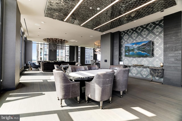 dining space with expansive windows and wood finished floors