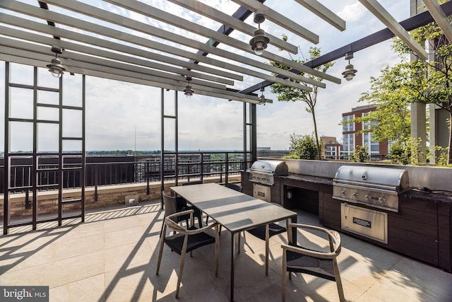 view of patio with a grill, an outdoor kitchen, a pergola, and outdoor dining space