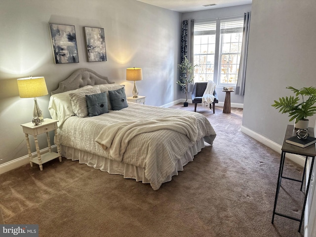 bedroom with visible vents, dark carpet, and baseboards