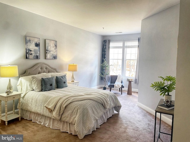 carpeted bedroom featuring visible vents and baseboards