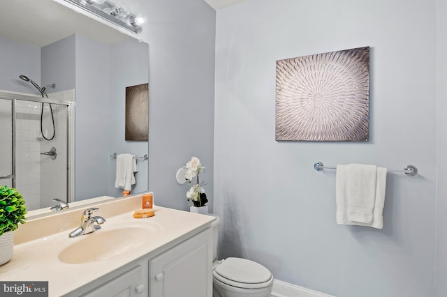 full bathroom with toilet, a tile shower, and vanity