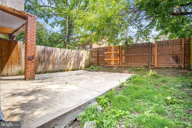 view of yard with a fenced backyard and a patio