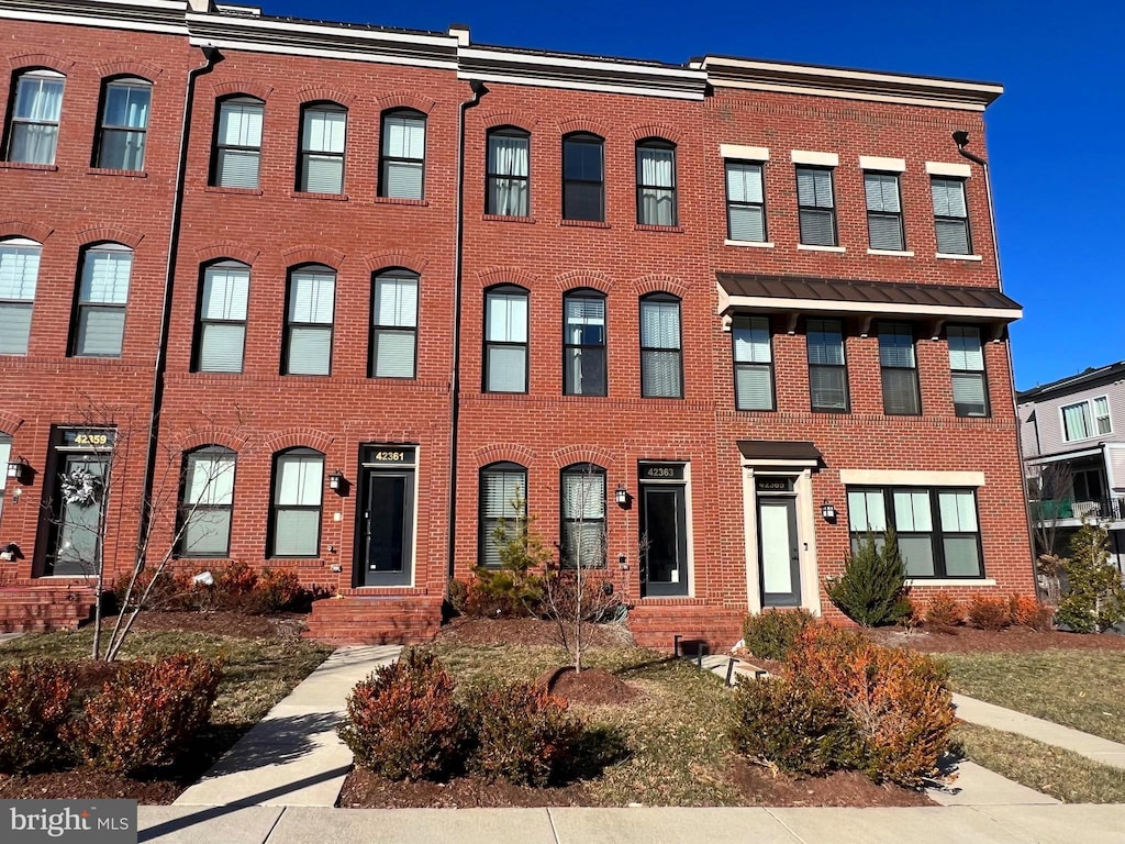 townhome / multi-family property with brick siding