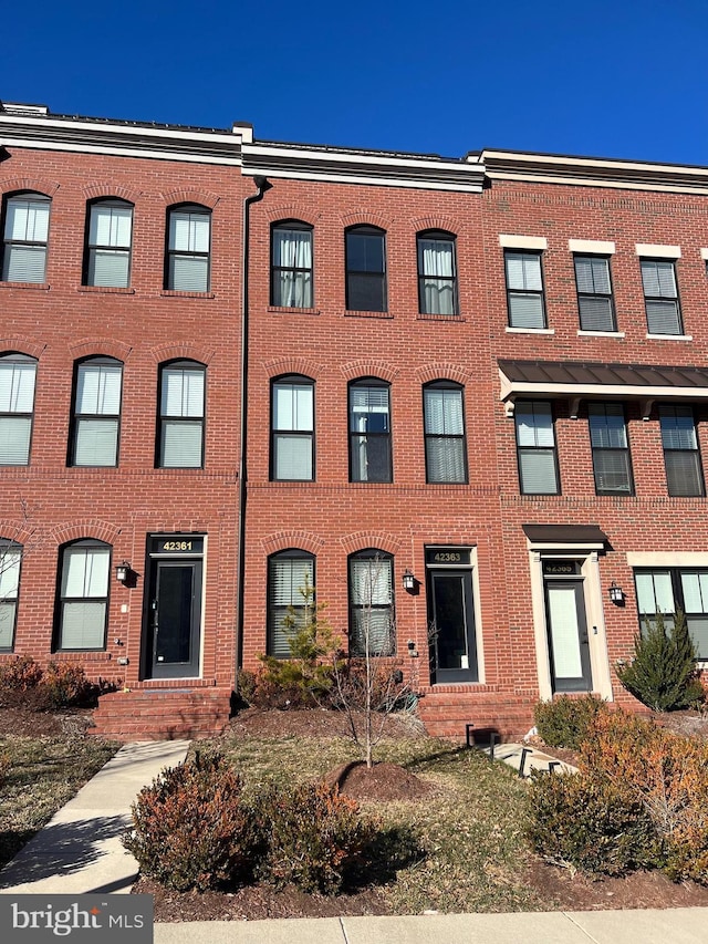 townhome / multi-family property with brick siding