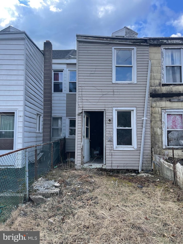 rear view of property with fence