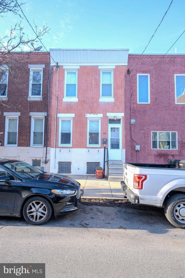 view of property featuring brick siding