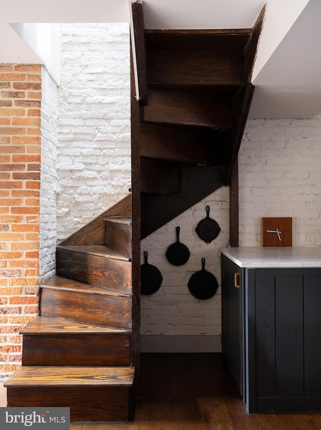 stairway featuring wood finished floors