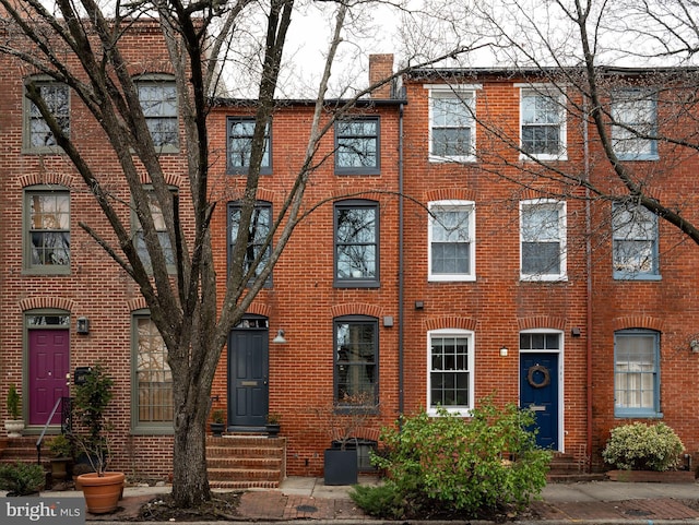 townhome / multi-family property with brick siding and entry steps