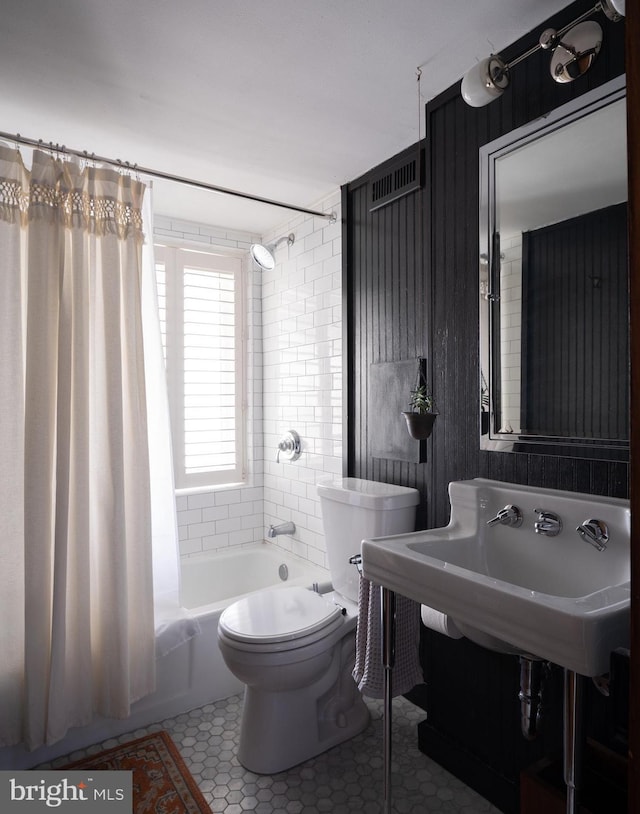 full bathroom with tile patterned flooring, toilet, and shower / bath combo