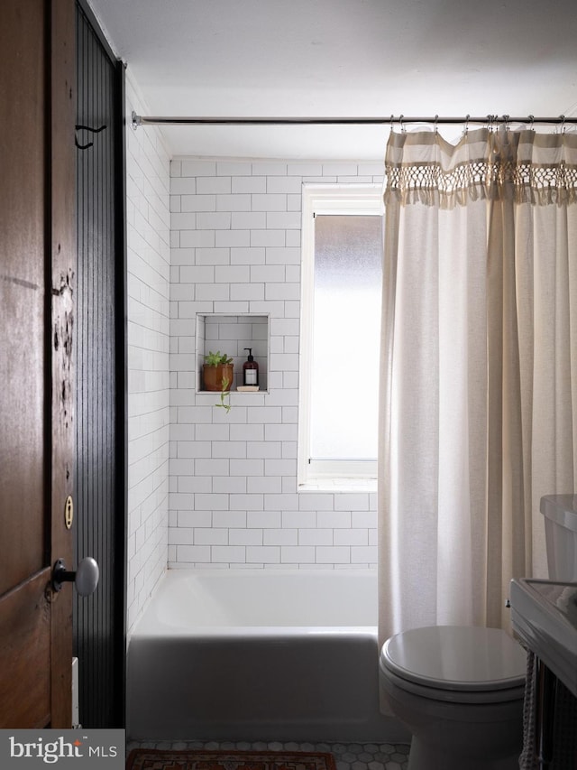 bathroom featuring toilet and shower / bath combo