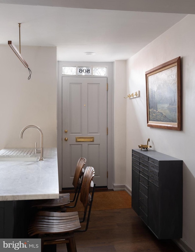 dining space featuring dark wood-style flooring