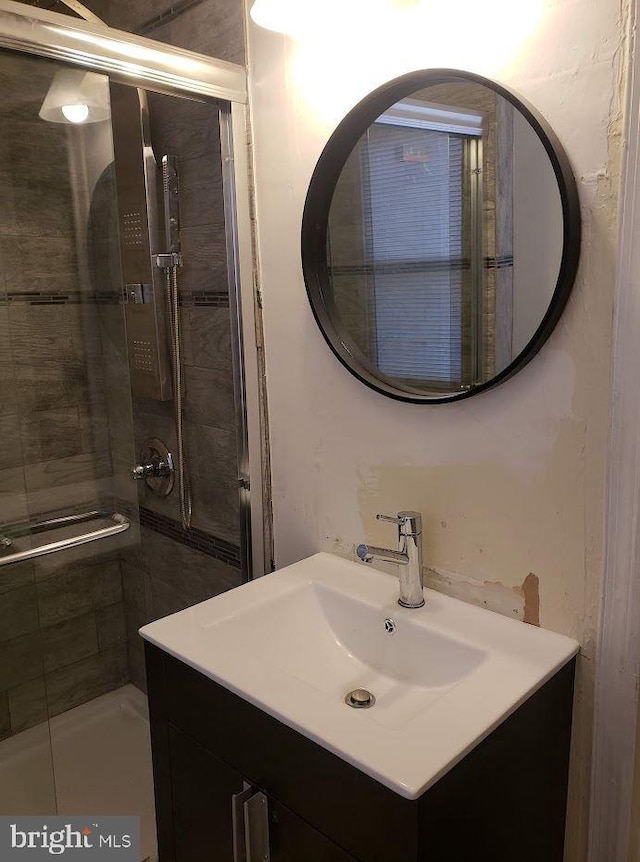 bathroom featuring a shower stall and vanity