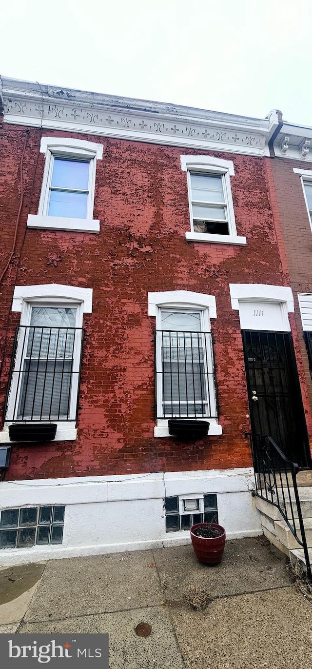 view of side of home featuring brick siding