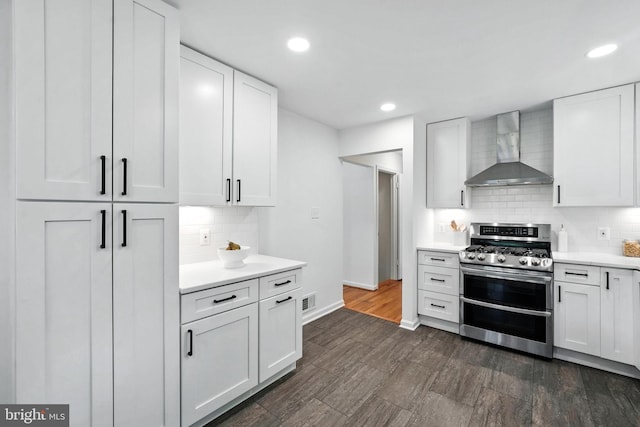 6910 Barnack Dr, Springfield, VA 22152 - kitchen featuring wall chimney exhaust hood, double oven range, tasteful backsplash, light countertops, and recessed lighting