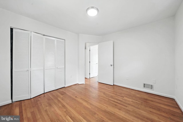 6910 Barnack Dr, Springfield, VA 22152 - unfurnished bedroom with light wood-style floors and a closet