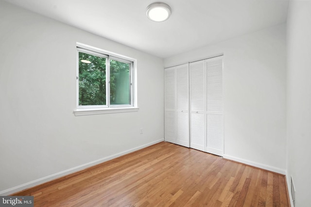 6910 Barnack Dr, Springfield, VA 22152 - unfurnished bedroom featuring light wood-type flooring and a closet
