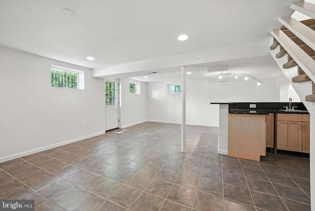 6910 Barnack Dr, Springfield, VA 22152 - below grade area with bar with sink, dark tile patterned floors, stairs, and recessed lighting