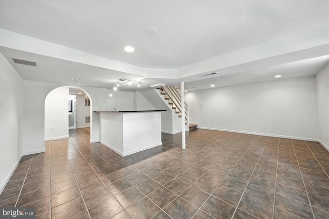 6910 Barnack Dr, Springfield, VA 22152 - finished below grade area with arched walkways, recessed lighting, dark tile patterned floors, and stairs