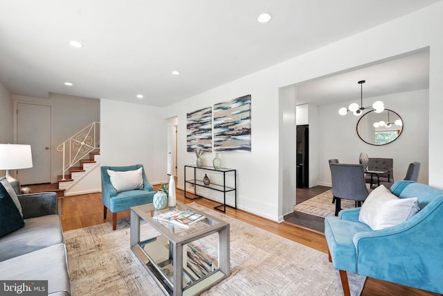 6910 Barnack Dr, Springfield, VA 22152 - living room featuring stairs, light wood-style floors, a chandelier, and recessed lighting