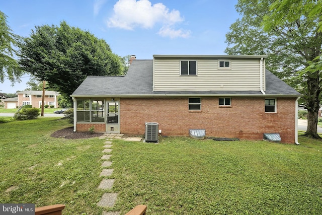 6910 Barnack Dr, Springfield, VA 22152 - back of property featuring a lawn, a sunroom, brick siding, and a shingled roof