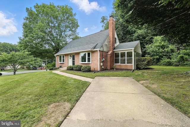 6910 Barnack Dr, Springfield, VA 22152 - view of front of property featuring brick siding, a sunroom, a front lawn, and a chimney