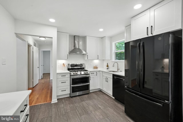 6910 Barnack Dr, Springfield, VA 22152 - kitchen featuring black appliances, wall chimney range hood, light countertops, white cabinetry, and recessed lighting