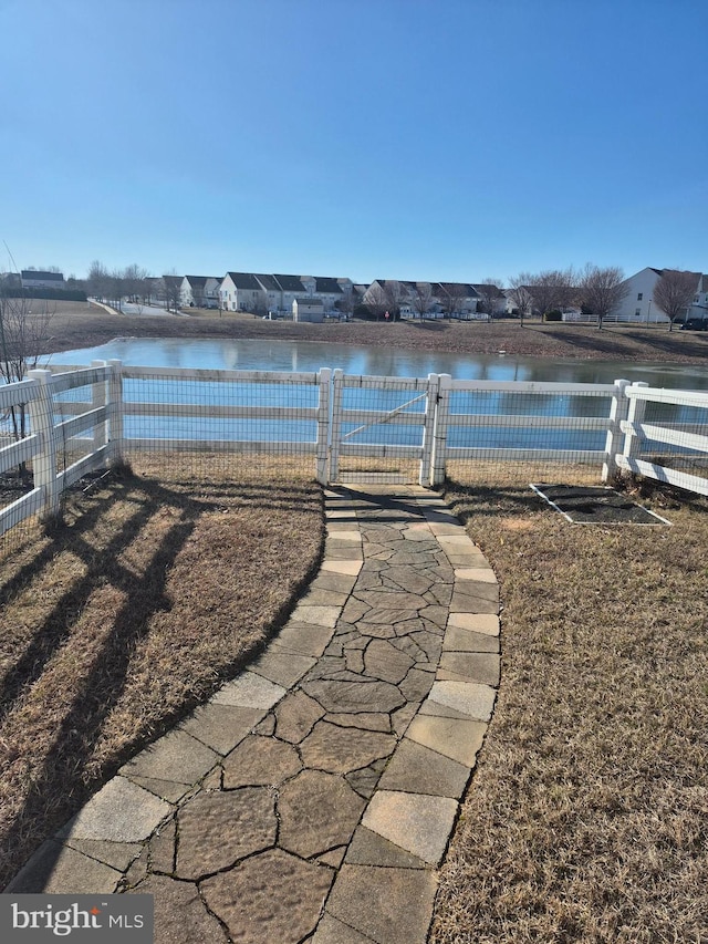 dock area with a water view and fence