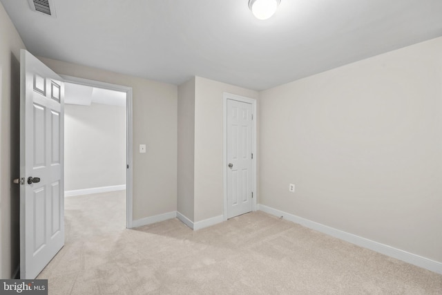 unfurnished bedroom featuring light carpet, baseboards, visible vents, and a closet