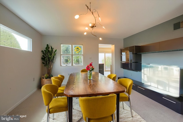 dining area featuring carpet floors, visible vents, plenty of natural light, and baseboards