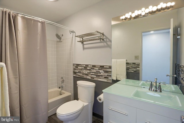 full bathroom featuring toilet, vanity, tile walls, decorative backsplash, and shower / bath combo with shower curtain