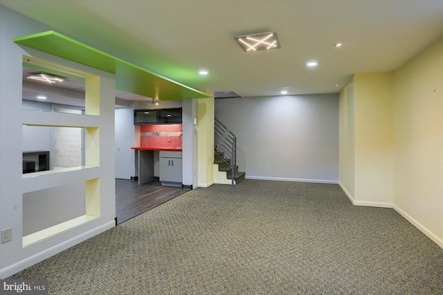 finished below grade area with recessed lighting, carpet flooring, stairway, and baseboards