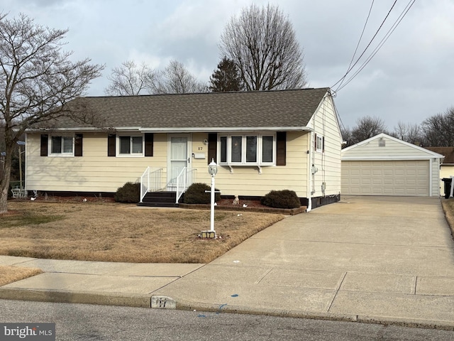 single story home featuring an outbuilding, a shingled roof, and a garage