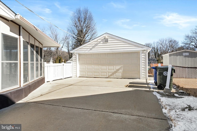 detached garage featuring fence