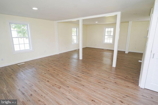 interior space featuring light wood finished floors, recessed lighting, and baseboards