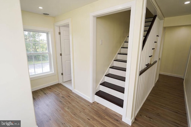 staircase with baseboards, visible vents, wood finished floors, and recessed lighting