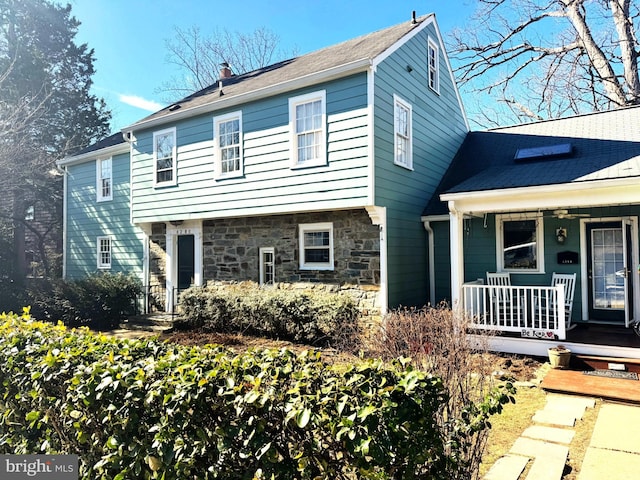 view of front facade featuring stone siding and a porch