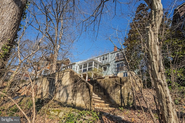 rear view of house featuring a chimney