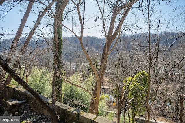 exterior space featuring a wooded view