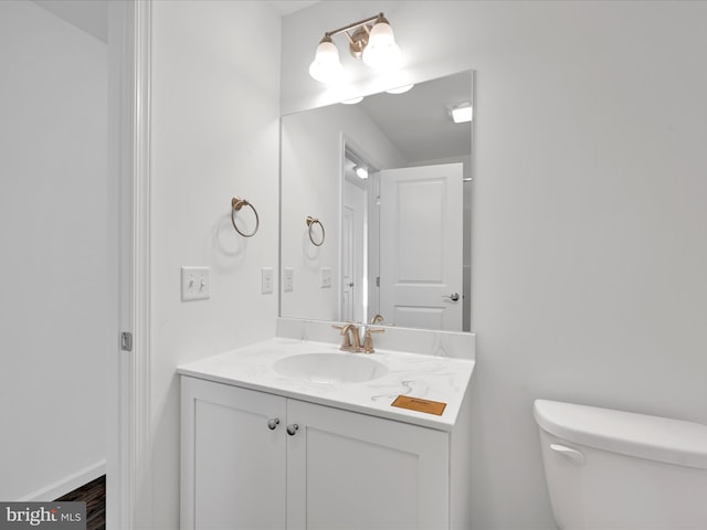 bathroom with toilet and vanity