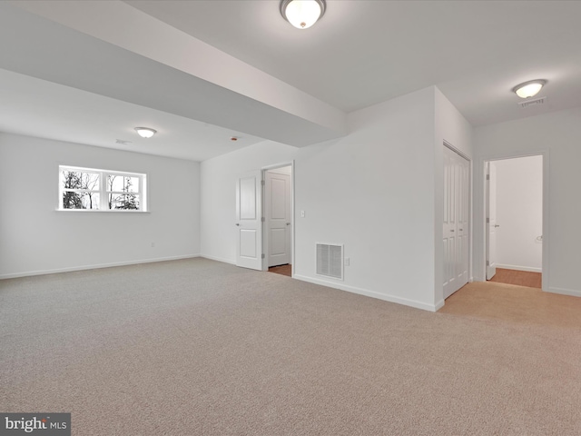 empty room with light carpet, baseboards, and visible vents