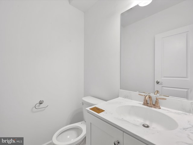 bathroom with toilet and vanity