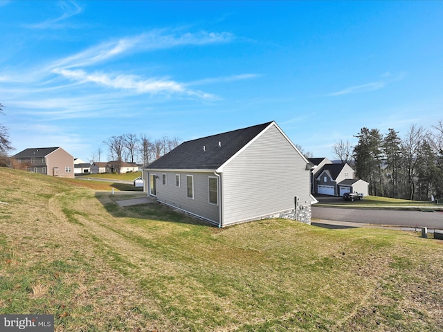 view of side of home featuring a lawn