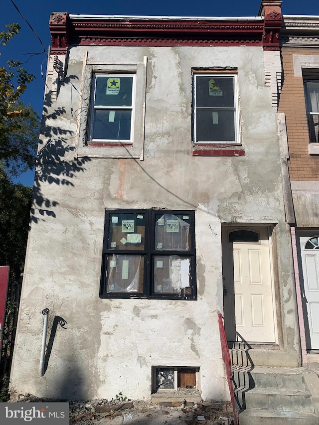 view of property with entry steps and stucco siding