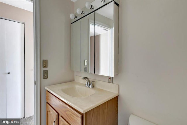 half bathroom with toilet and vanity