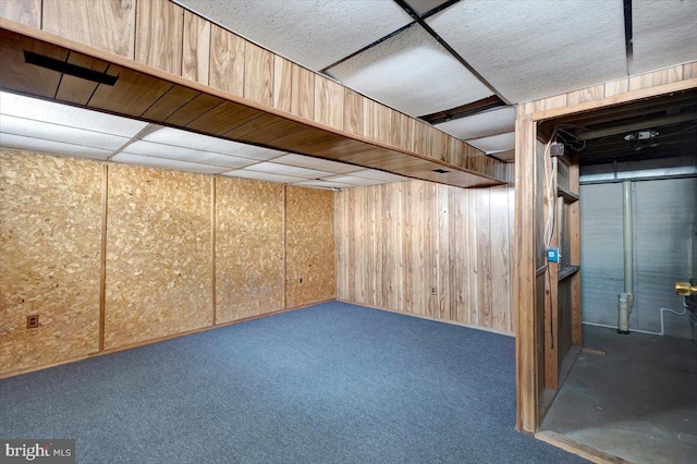 finished basement featuring wooden walls and carpet flooring