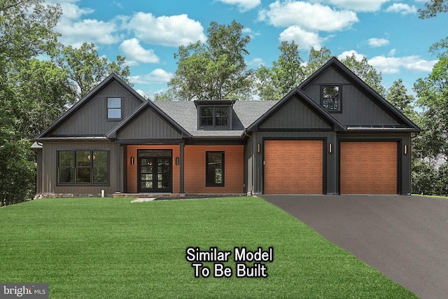 view of front of property with a front yard, roof with shingles, driveway, and an attached garage