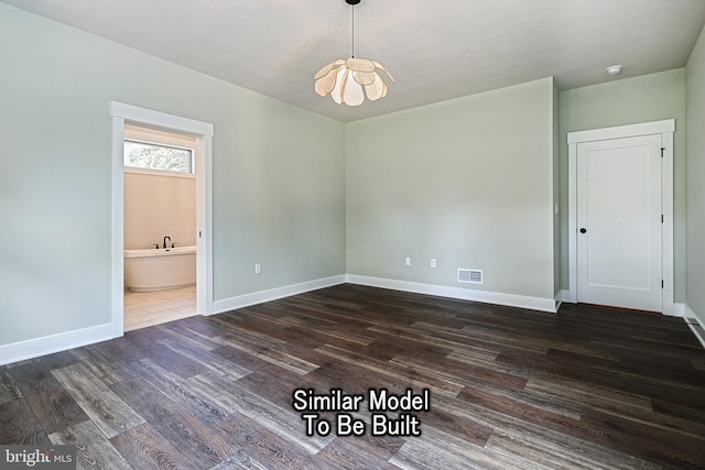 unfurnished dining area featuring dark wood-style flooring, visible vents, and baseboards