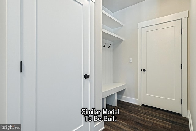 mudroom featuring dark wood finished floors and baseboards