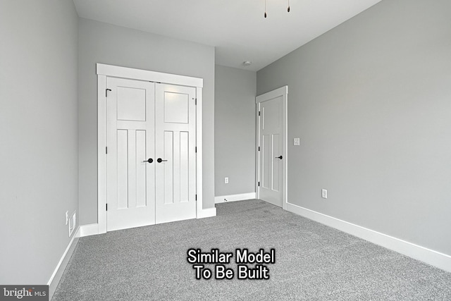 unfurnished bedroom featuring a closet, carpet flooring, and baseboards