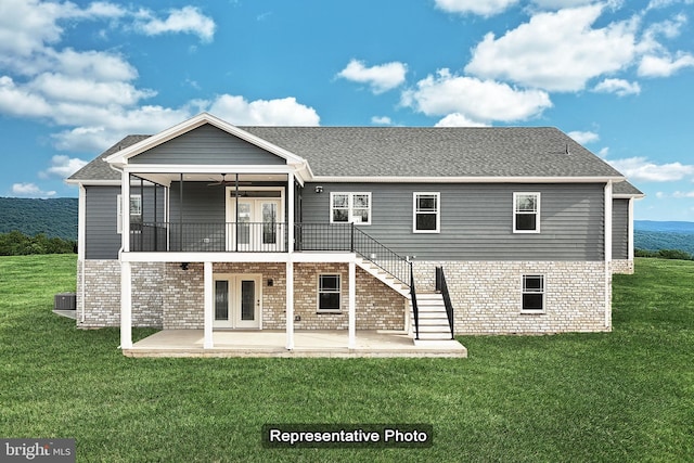 rear view of property with ceiling fan, a patio, a yard, french doors, and stairway